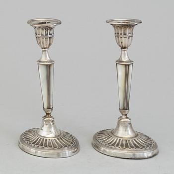 HARRISON BROTHERS & HOWSON, a pair of silver and mother of pearl candlesticks from Sheffield, England, 1926.