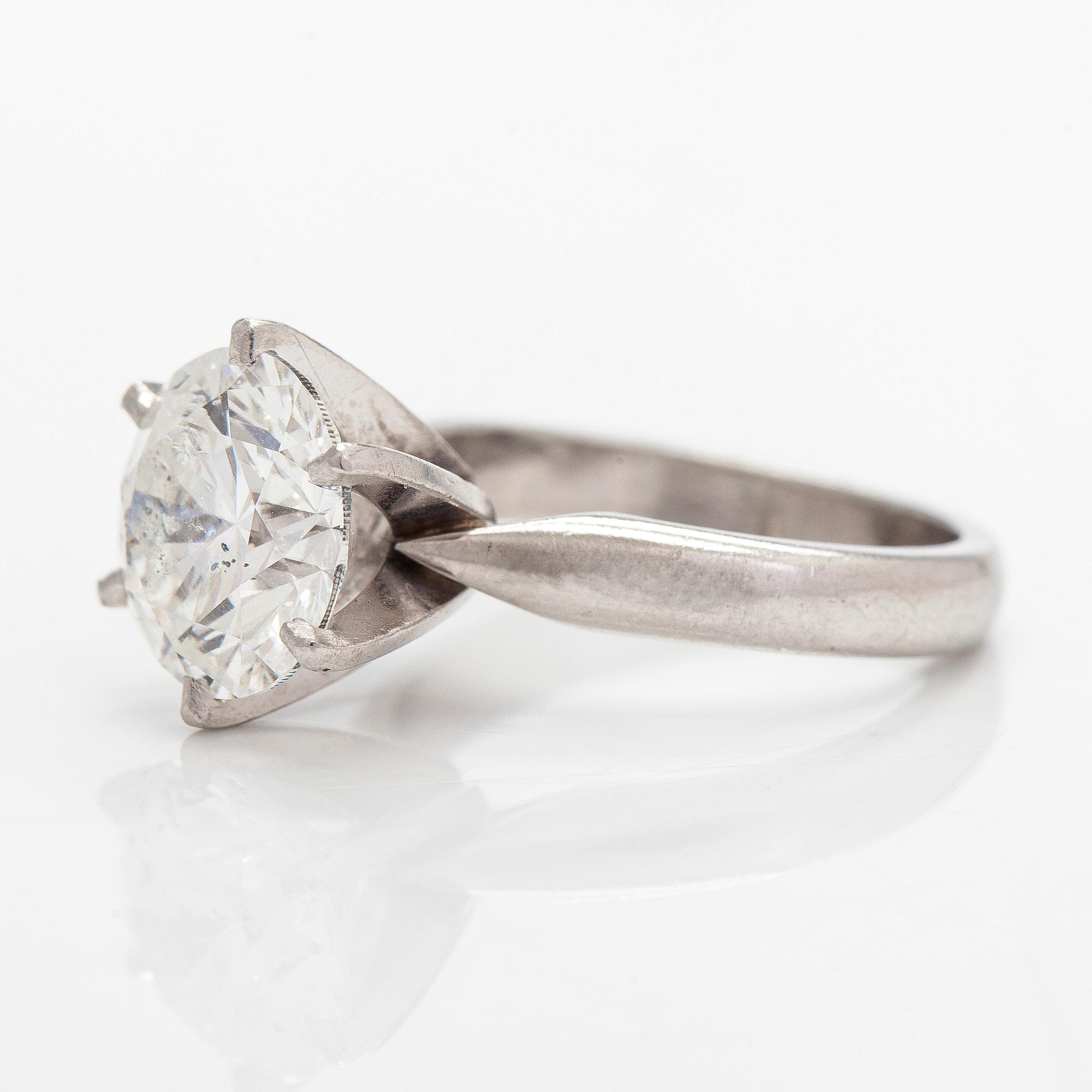 A platinum ring, with a brilliant-cut diamond approximately 3.10 ct. Domino Jewellery, Birmingham, England.