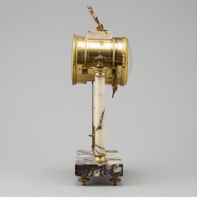 A marble and brass pendulum clock, first half of the 20th century.