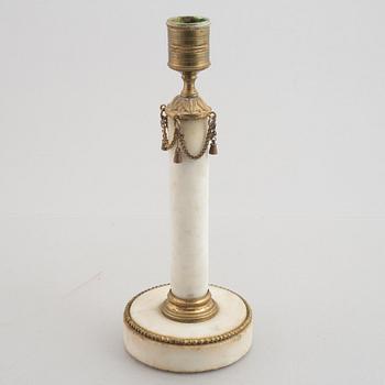 A late Gustavian gilt brass and marble candlestick, late 18th century.