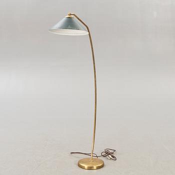 A 1950s brass floor lamp.