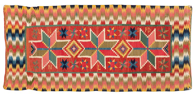 A carriage cushion, double-interlocked tapestry, 108 x 50 cm, Oxie district, Scania, signed LNS SPD NLS, Ca 1800-1825.