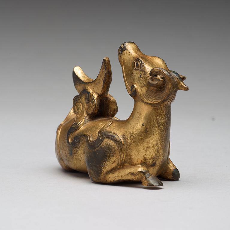 A gilt bronze figure of a reclining mythical animal, Qing dynasty, 19th Century.