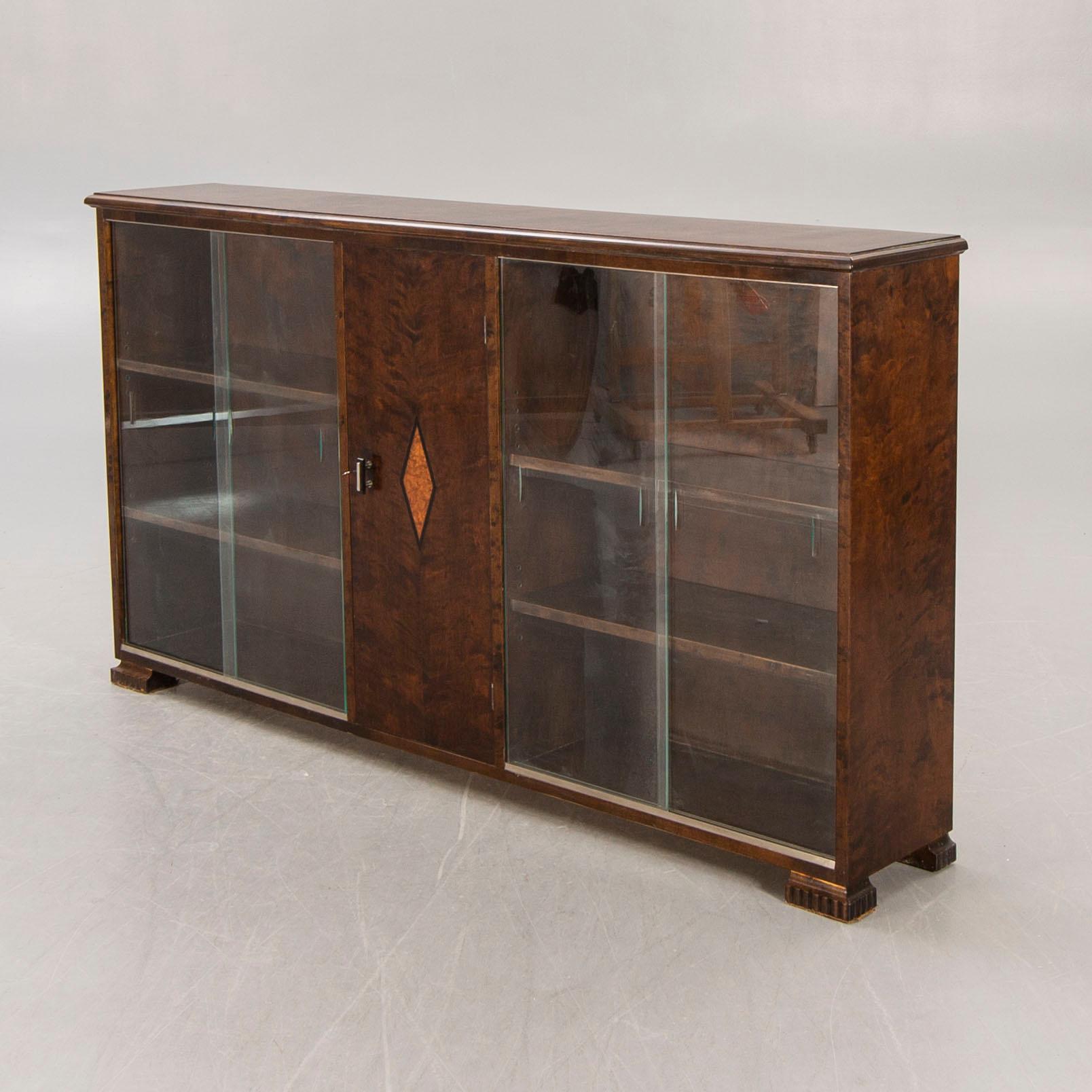 A 1930s birch book cabinet.