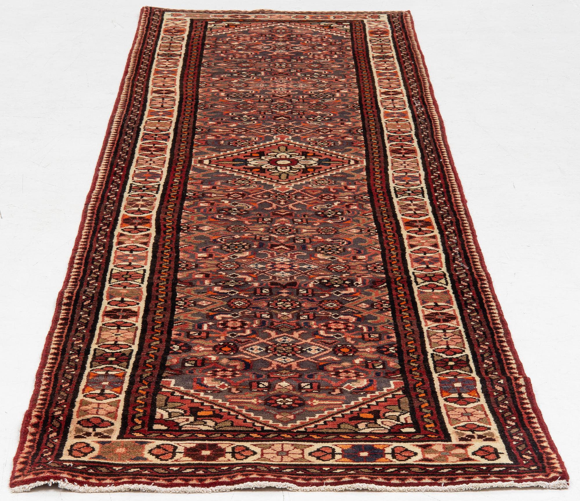 A runner  carpet, Hamadan, 305 x 80 cm.