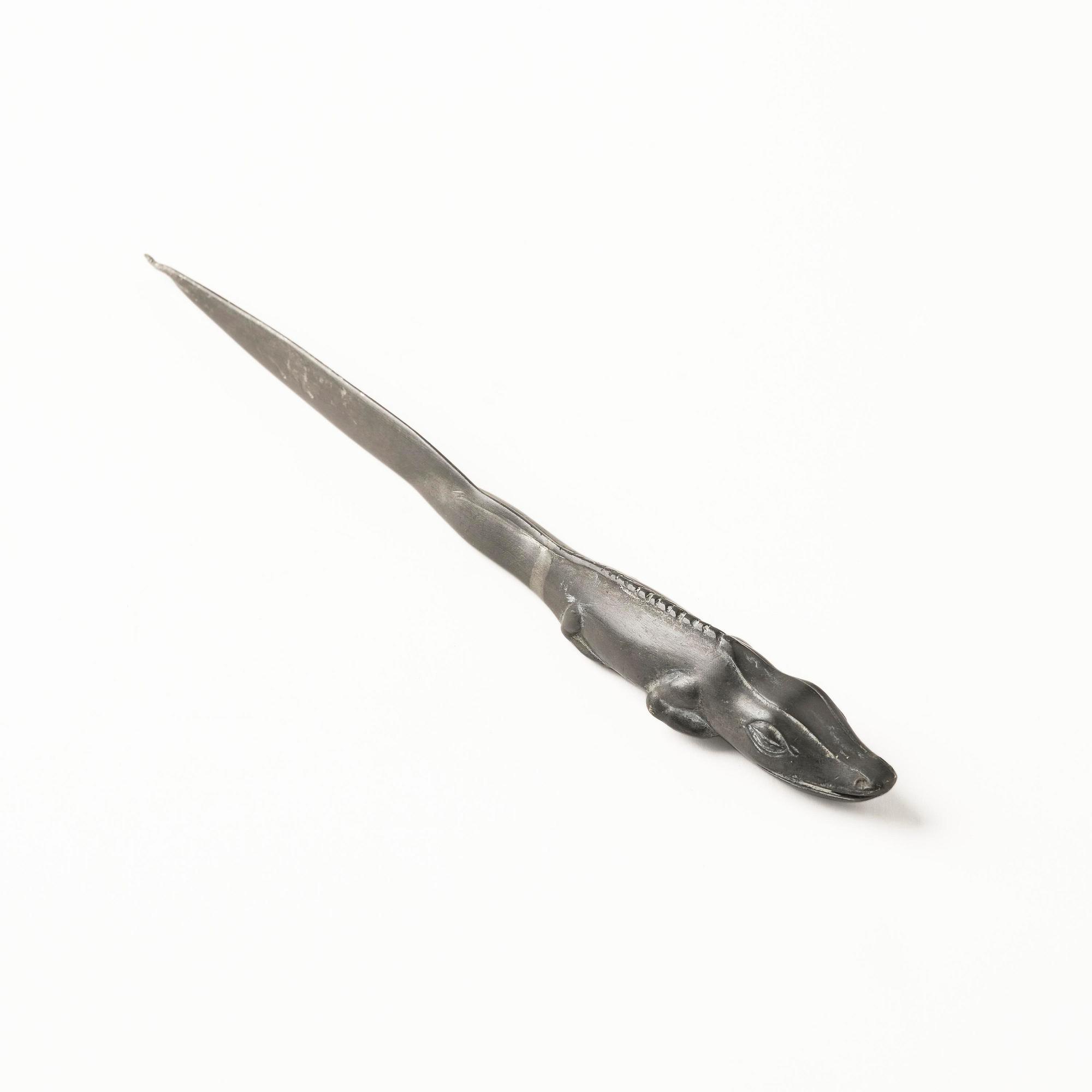 Firma Svenskt Tenn, a pewter hand mirror model A 1497 and a letter opener in the shape of an alligator, Stockholm, 1930s-40s.