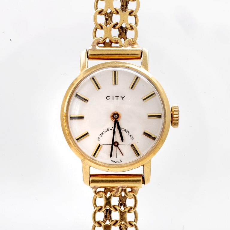 An 18K gold City wristwatch.