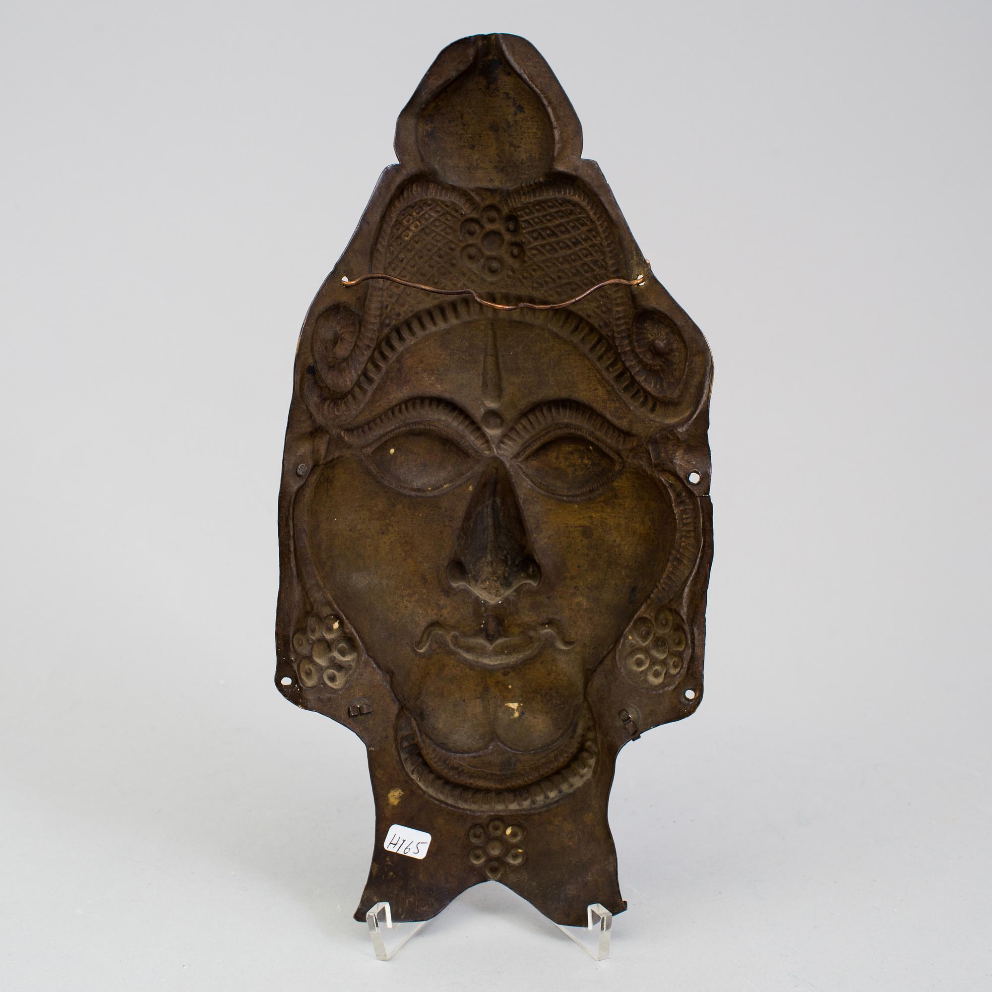 A copper alloy mask of a deity, south east asia, presumably 19th Century.