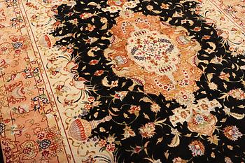 A Tabriz rug, a. 210 x 147 cm.
