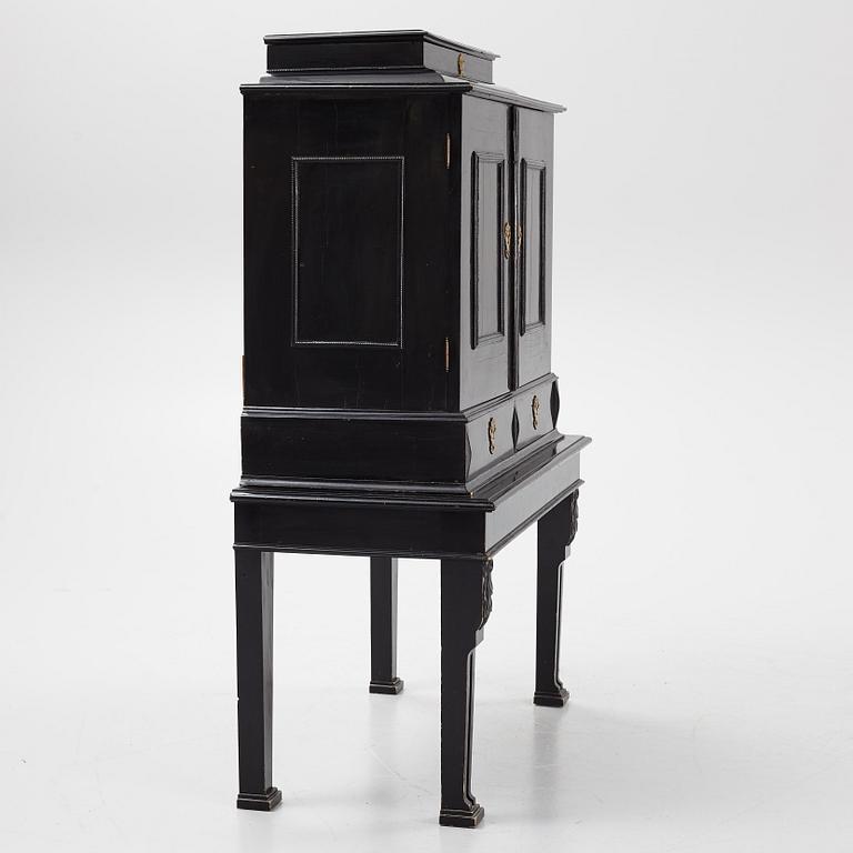 A South-German Baroque ebonized collector's cabinet on stand, circa 1700.