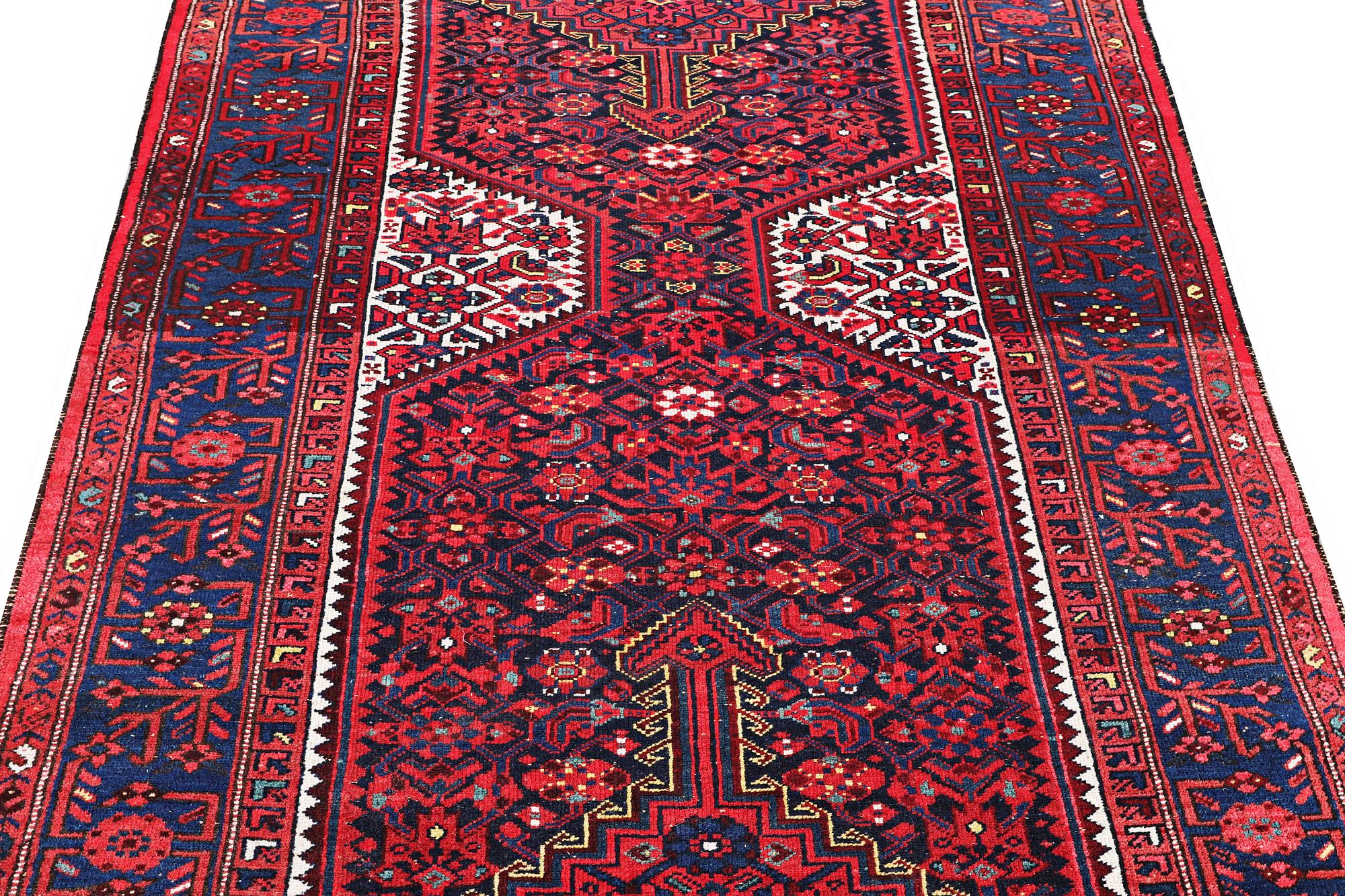 A Hosseinabad carpet, c. 391 x 135 cm.