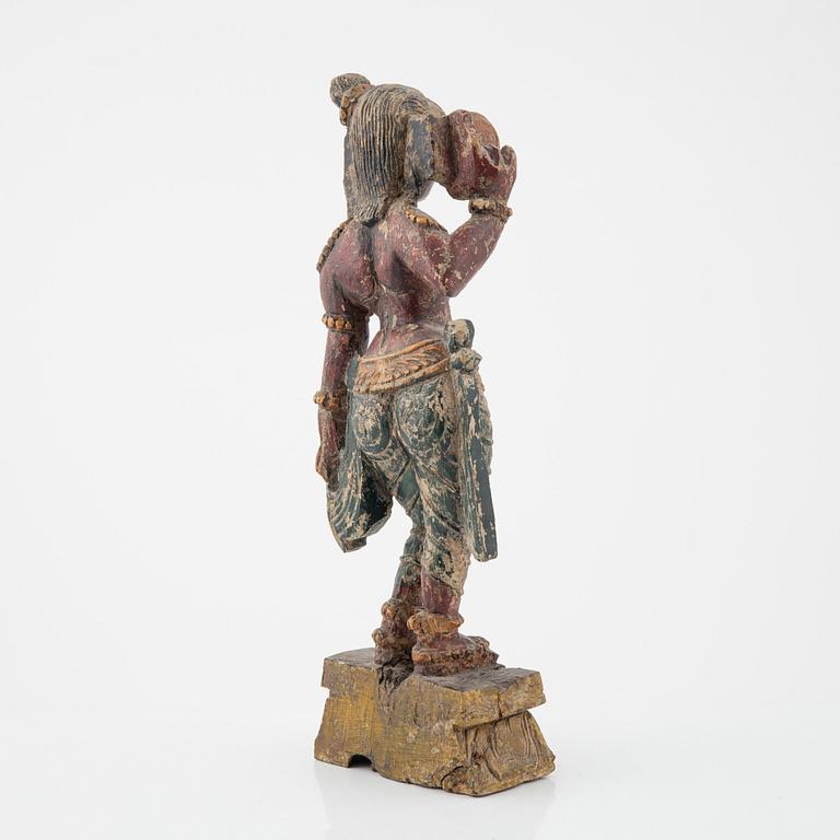 A wooden sculpture of a deity, Indian, 20th Century.