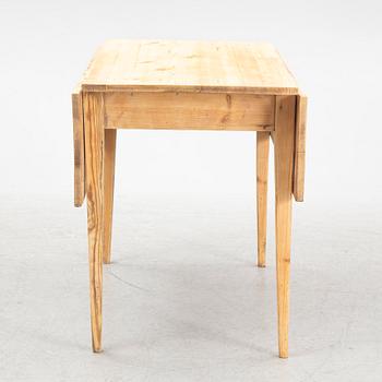 A drop-leaf table, circa 1900.