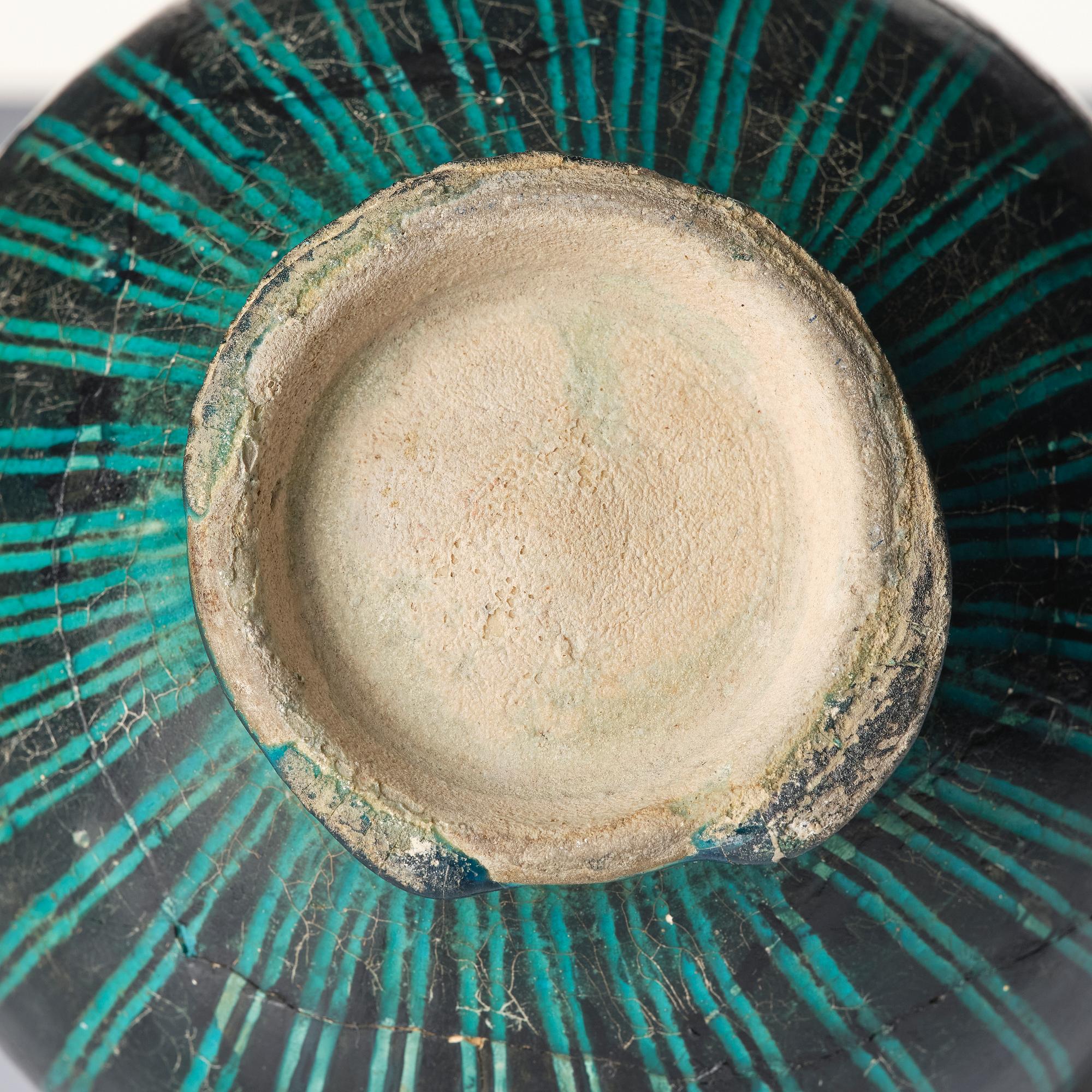 A Kashan Silhouette ware turquoise glazed pottery jug, central Iran, circa 1200.