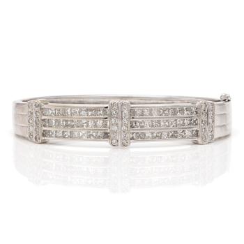 A bangle with princess and round, faceted diamonds.