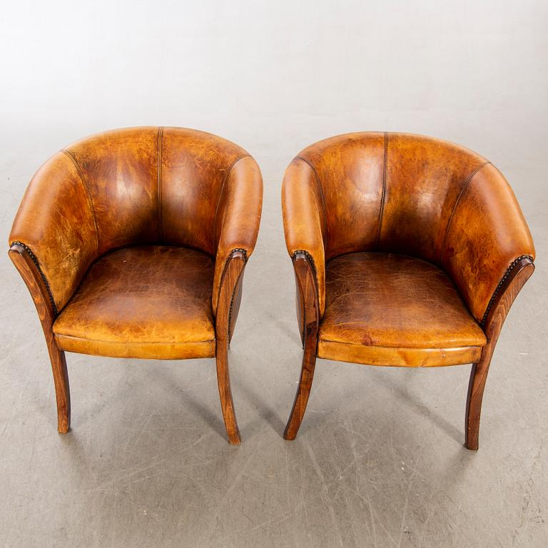 A pair of leather armchairs later part of the 20th century.