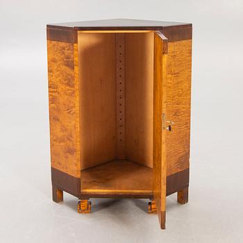 A 1930s birch corner cabinet.