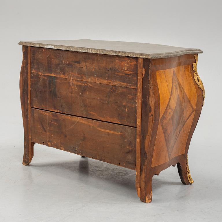 A Swedish rococo parquetry and gilt-bronze mounted commode in the manner of C. W. Hein, later part of the 18th century.