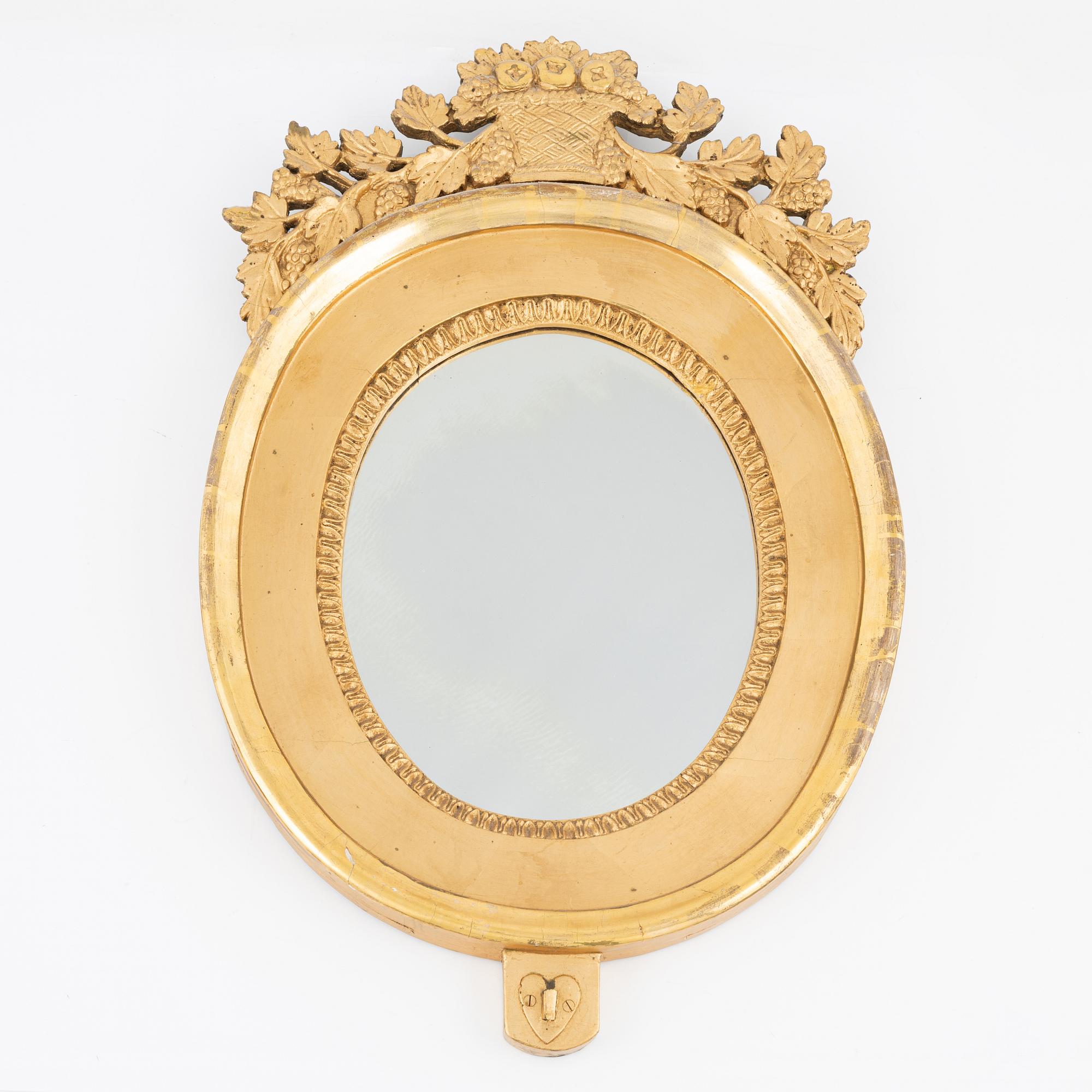 An Empire giltwood mirrored wall sconce by J. M. Berg (active in Gothenburg 1803- ca 1837).