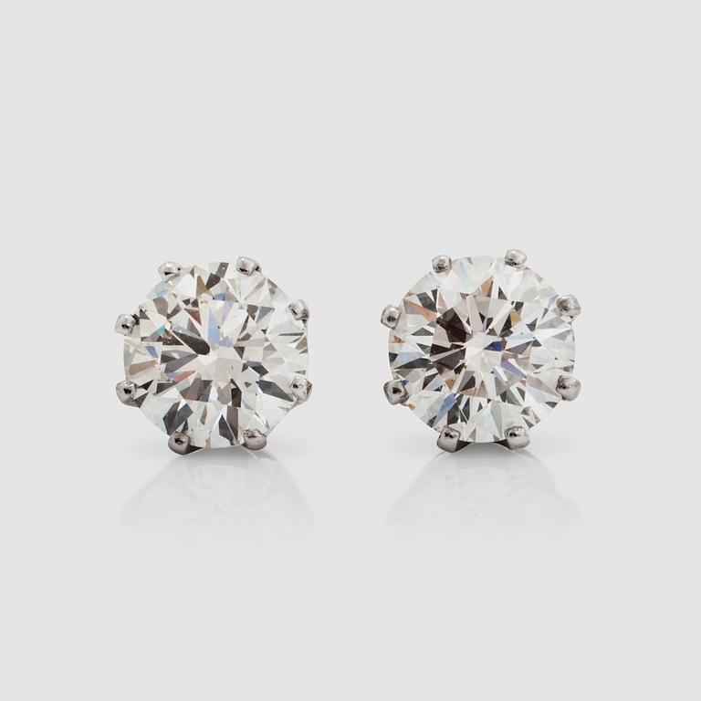 A pair of diamond solitaire, 2.01 cts and 2.04 cts, earrings. Quality circa L/VS2.