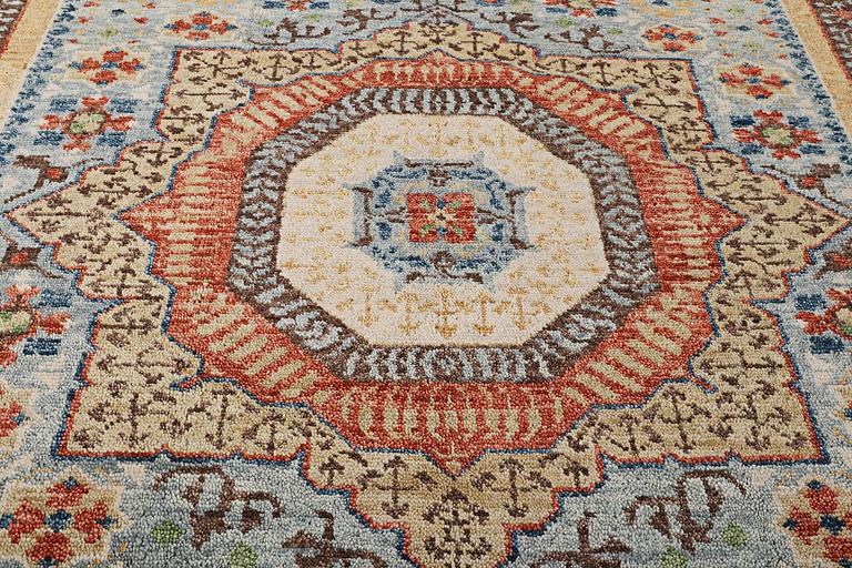 An oriental carpet with Mamluk design, c. 356 x 255 cm.