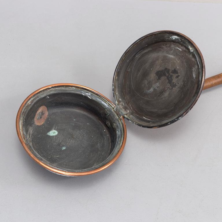 A 18th century copper bed warmer.
