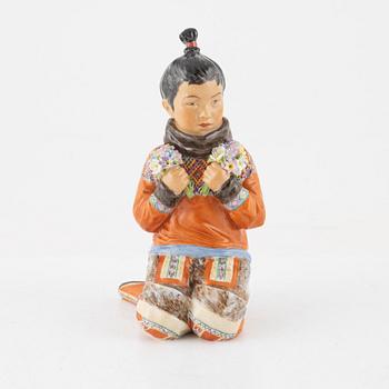 A Royal Copenhagen porcelain figure of an innuit from Grönland, Denmark, early 20th Century.