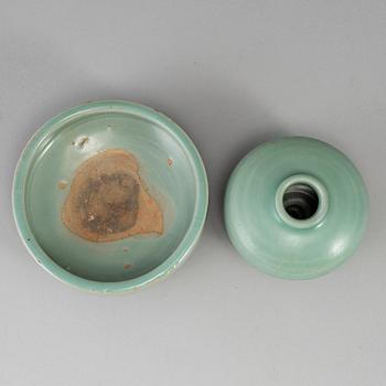 A celadon glazed tripod censer and a vase, Ming dynasty (1368-1644).