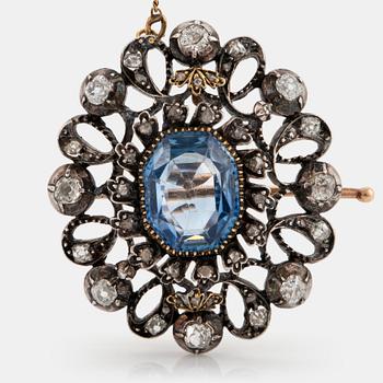 830. A 14K gold and silver brooch set with a synthetic sapphire and old- and rose-cut diamonds.