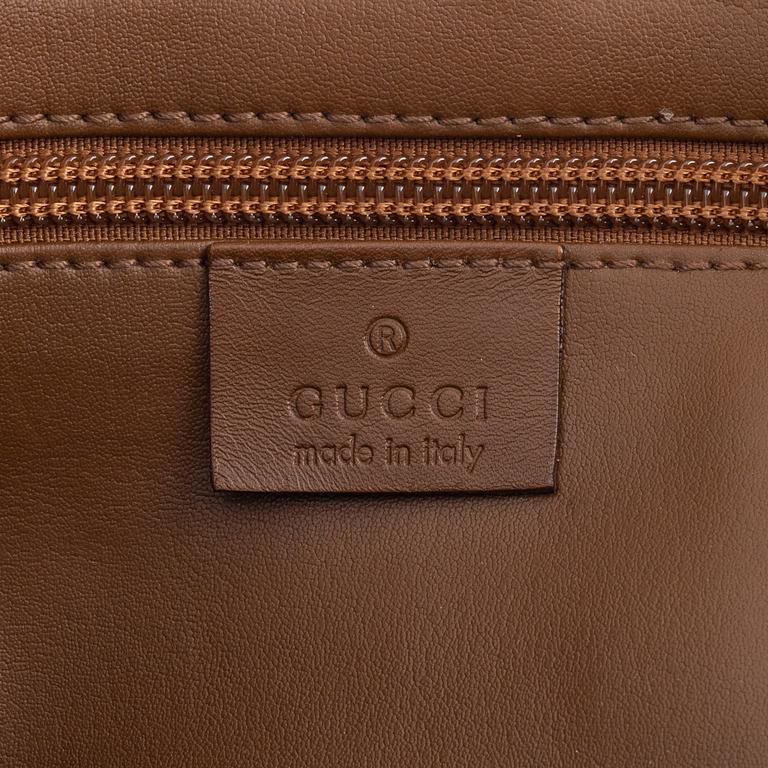 Gucci, a logo canvas tote bag.