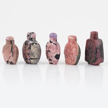 Nine Chinese snuff bottles in mottled stone, 20th century.