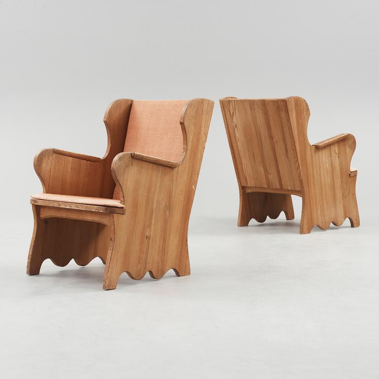 A pair of stained pine armchairs attributed to Axel Einar Hjorth, Nordiska Kompaniet, Sweden 1930's.