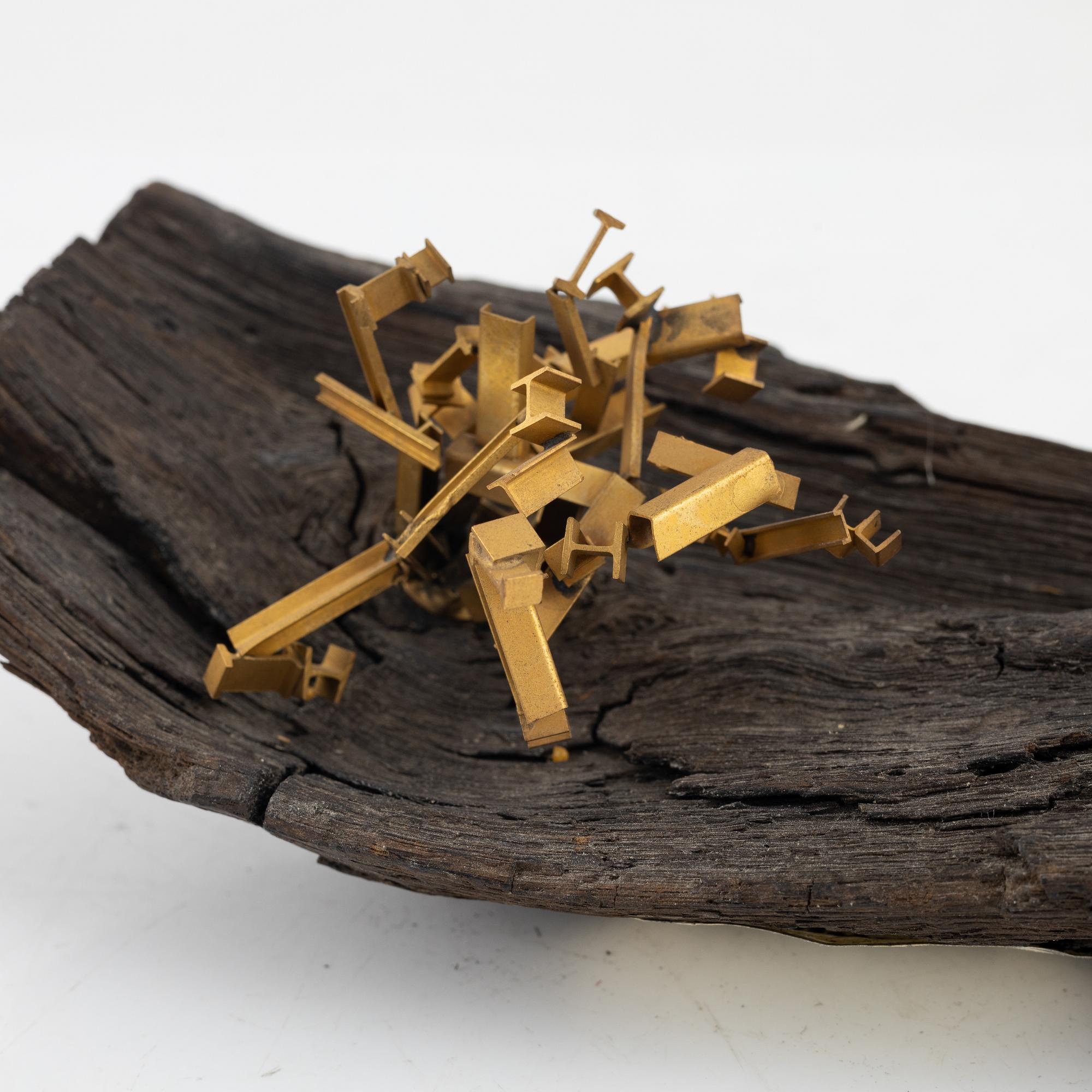 Arne Jones, sculpture, brass on driftwood, signed on label by the estate.