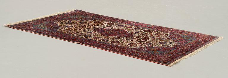 A CARPET, a semi-antique silk Kashan, ca 208,5 x 130 cm.