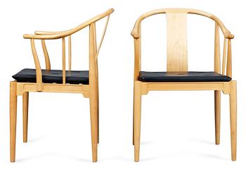 A pair of Hans J Wegner cherrywood "China chairs, Fritz Hansen, Denmark 1987 and 1988.