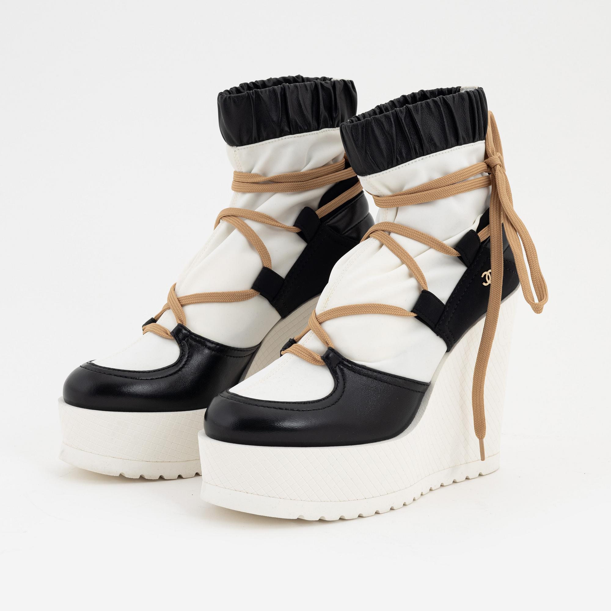 A pair of black leather and white canvas boots, French size 37.