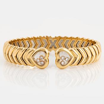 A Chopard "Happy Diamond" bangle in 18K gold.