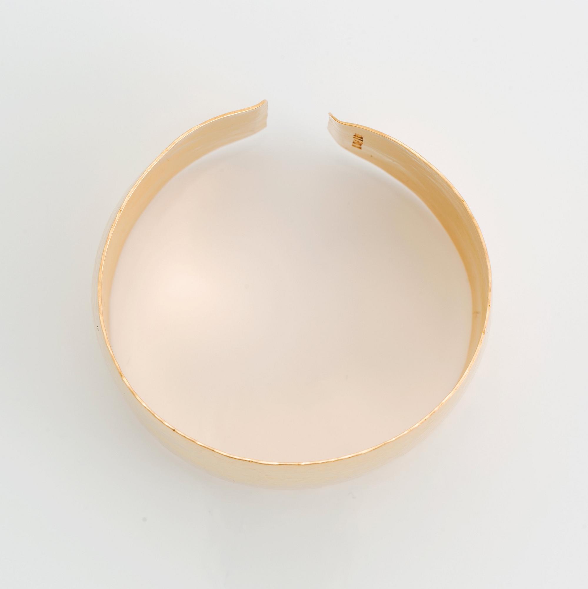 An 18K gold bangle.