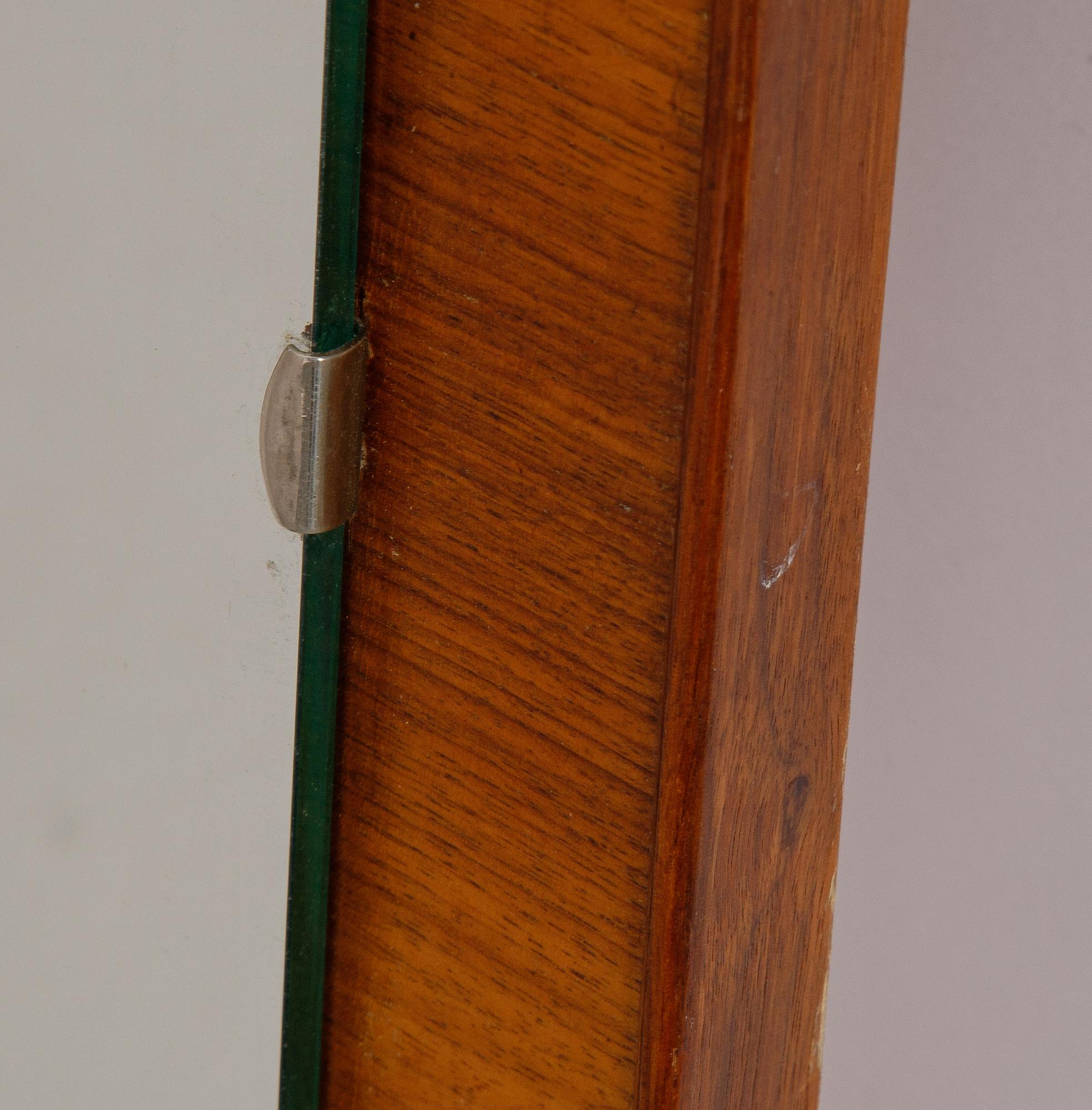 A teak mirror, mid 20th century.