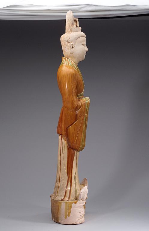 A potted, partially glazed tomb figure of a guardien, Tang dynasty (618-907).