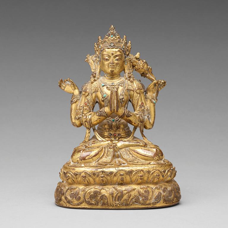 A gilt copper alloy four armed Sadaksari Avalokiteshvara, Tibet/Nepal, 15th Century or older.