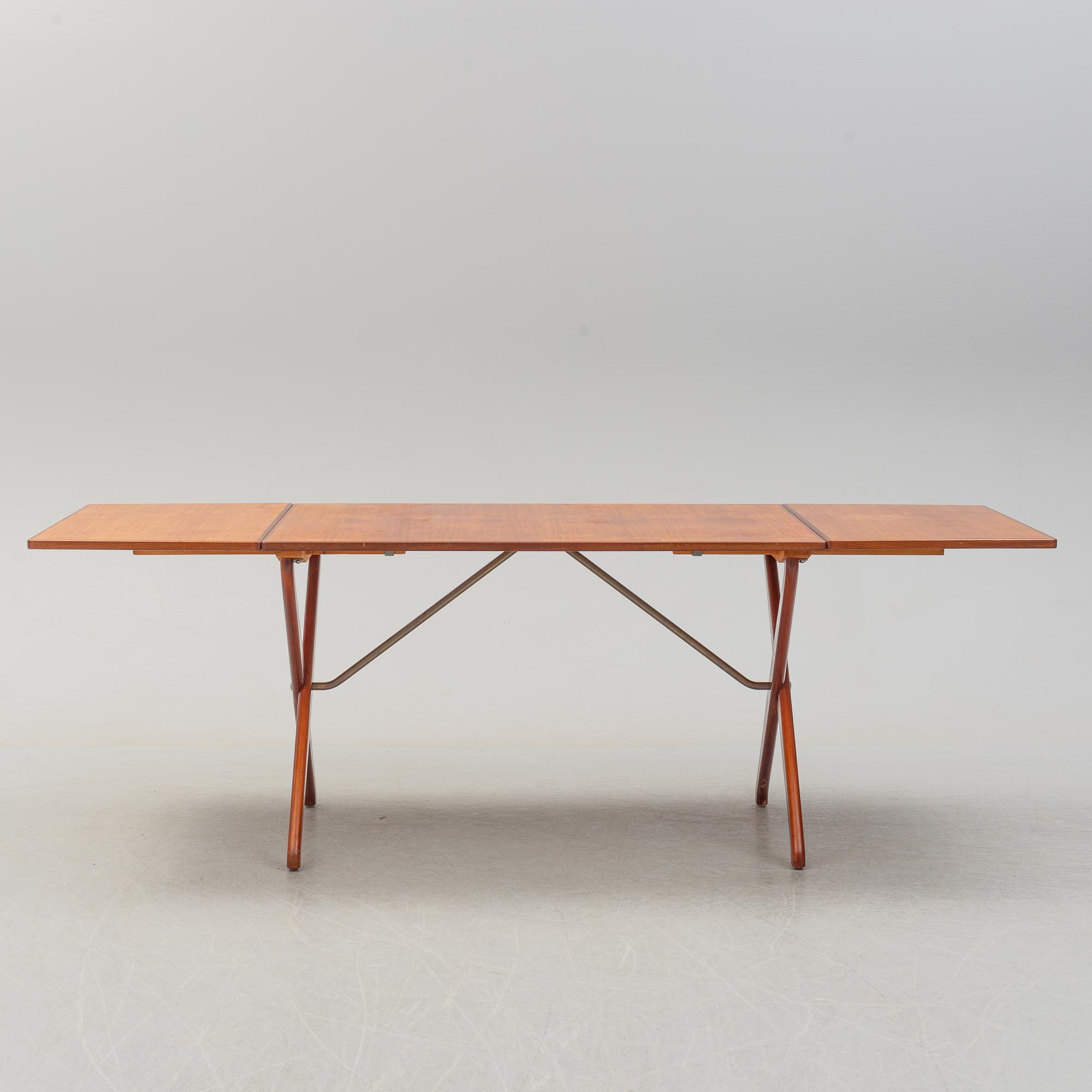 A teak veneer and stained beech dining table, mid 20th Century.