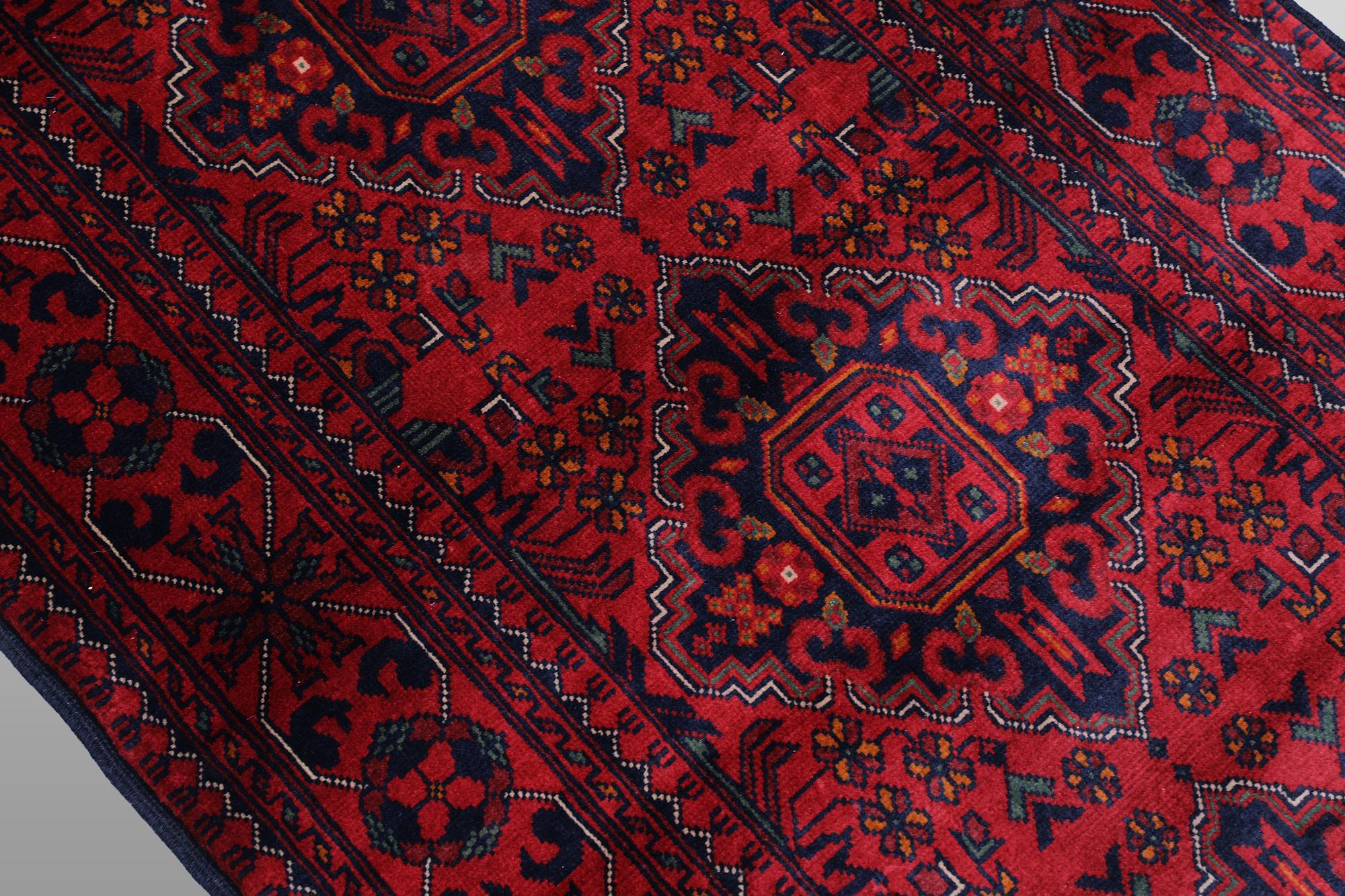 A Afghan runner carpet, 388 x 79 cm.