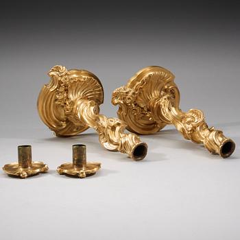 A pair of Louis XV 18th century gilt bronze candlesticks after the model by Juste-Aurèle Meissonnier.