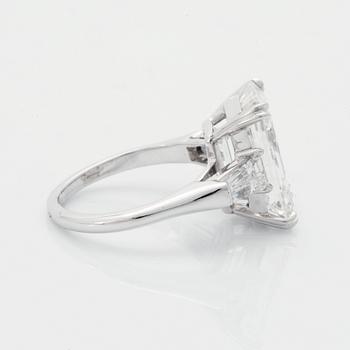 A platinum ring set with an emerald-cut diamond.