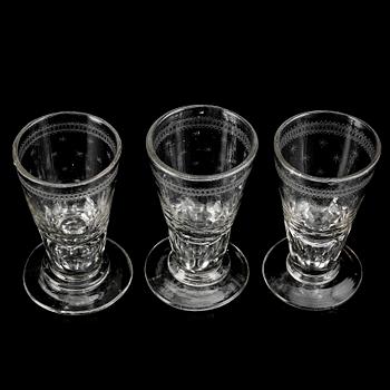 A glass bottle and three vodka glasses, 19th Century.