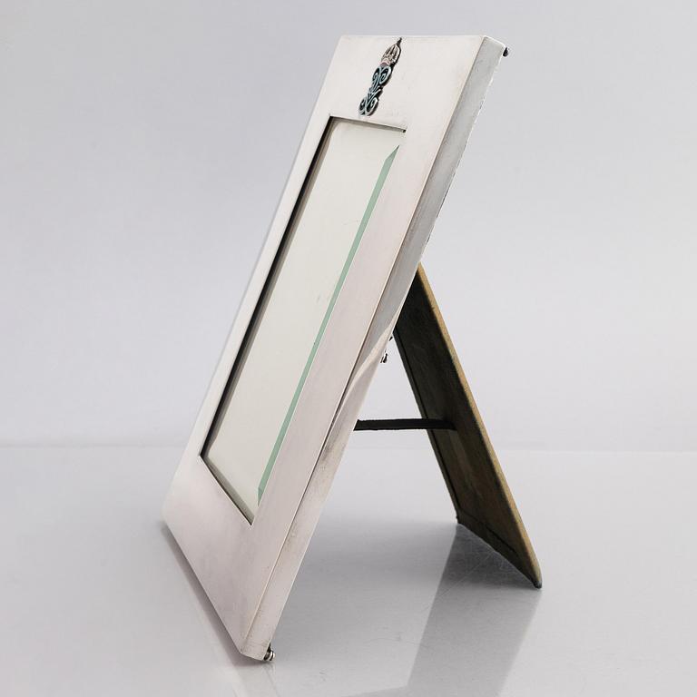 A silver and enamel frame with glass, mark of CG Hallberg, Stockholm 1935.