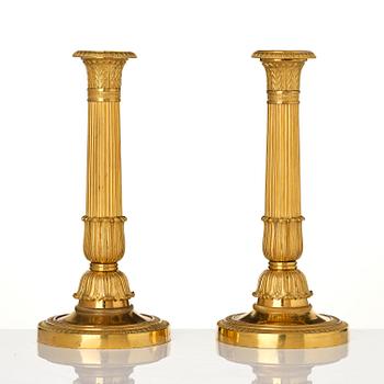 A pair of French Empire gilt-bronze candlesticks, early 19th century.