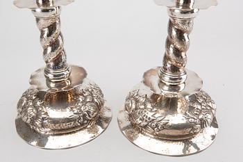 A pair of silver baroquestyle candlesticks. W.H.H, Stockholm. 1935. Filled foot.