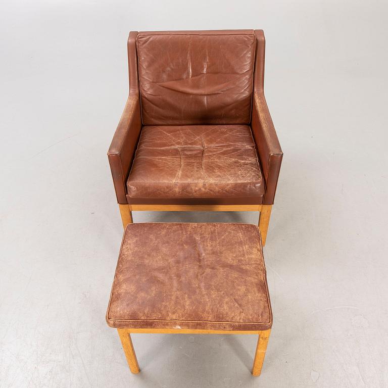 A Kai Lyngfeldt Larsen leather armchair and footstool for Söborg Möbler, Denmark, last part of the 20th century.